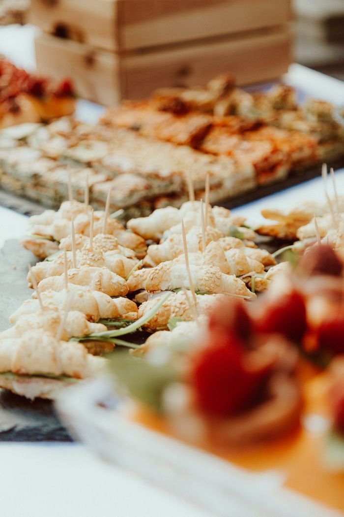 Close-up of assorted finger foods with appetizers and desserts for an event.